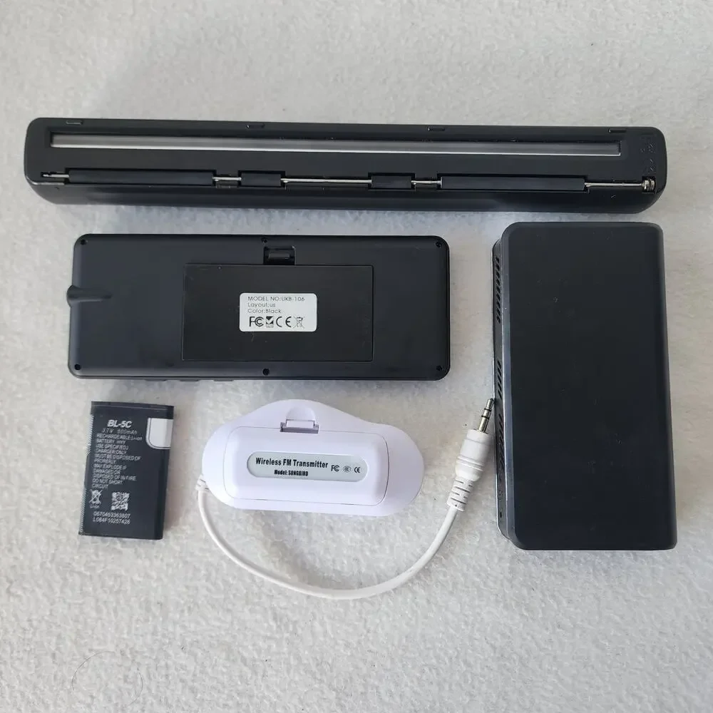 Four Merlin gadgets portable scanner keyboard projector amfm transmitter